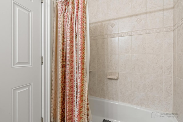 bathroom with shower / bath combination with curtain