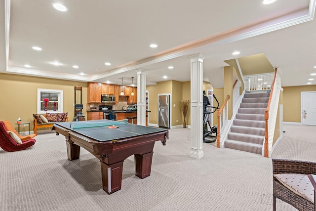 rec room featuring recessed lighting, a raised ceiling, decorative columns, and light colored carpet