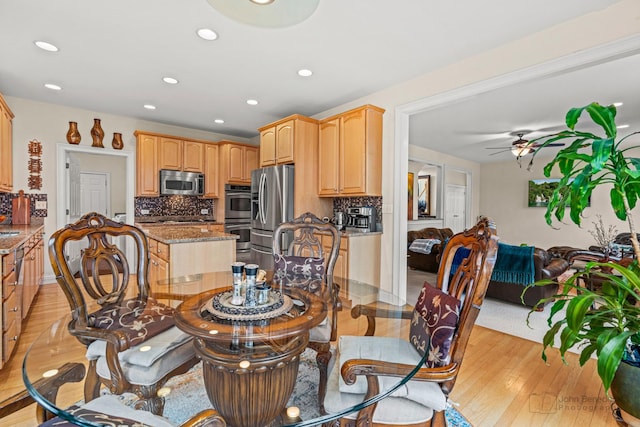 dining room with light wood-style floors, ceiling fan, and recessed lighting