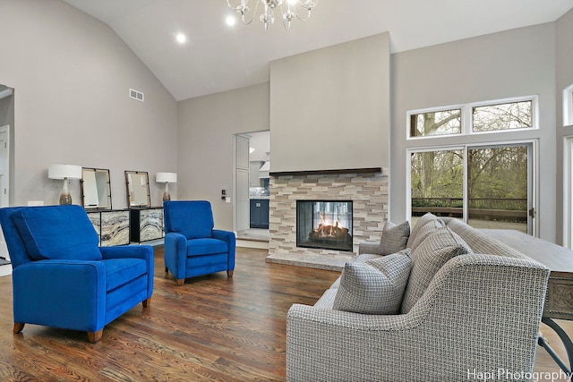 living room with a notable chandelier, high vaulted ceiling, dark hardwood / wood-style floors, and a multi sided fireplace