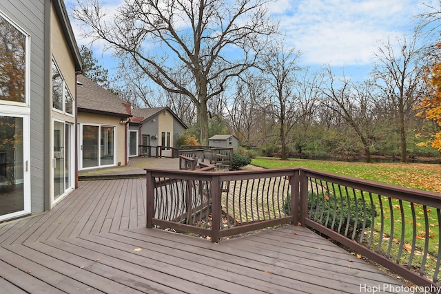 wooden deck with a lawn