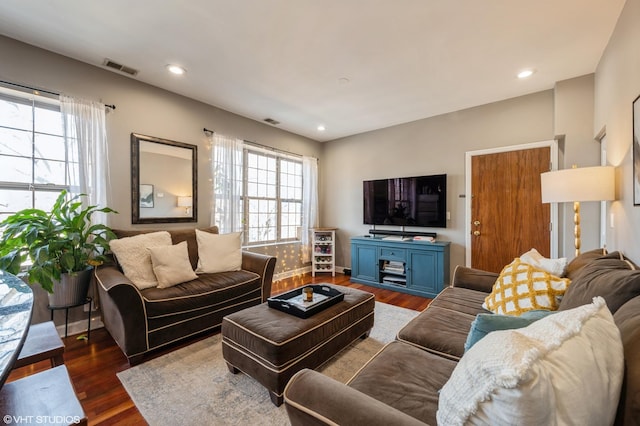 living area with recessed lighting, visible vents, and dark wood finished floors