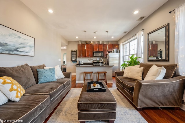 living area featuring dark wood finished floors, visible vents, and recessed lighting