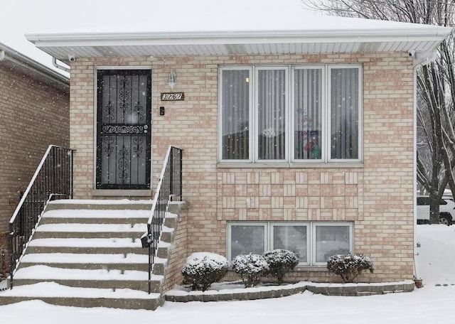 view of snow covered property entrance