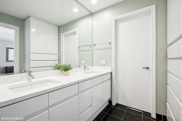 full bath with double vanity, recessed lighting, a sink, and tile patterned floors