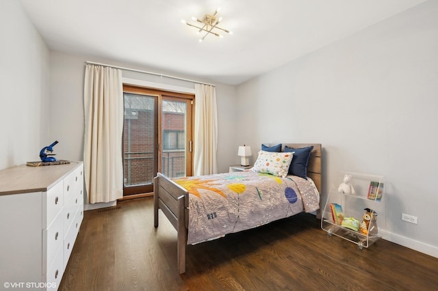 bedroom featuring access to outside, baseboards, and wood finished floors