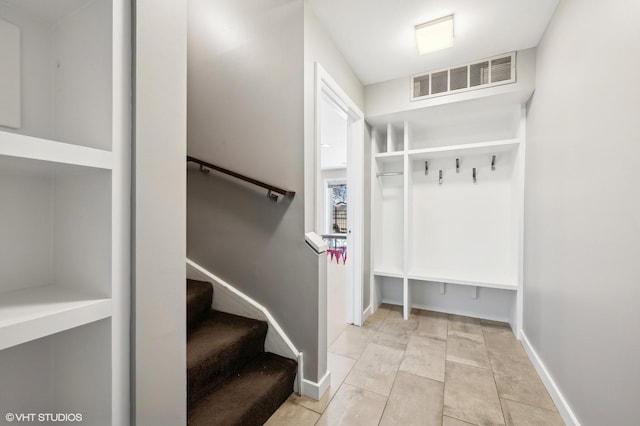 mudroom with baseboards, visible vents, and tile patterned floors