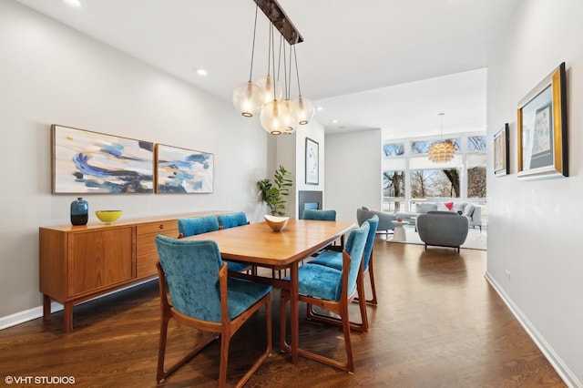 dining room featuring baseboards, dark wood finished floors, a notable chandelier, and recessed lighting