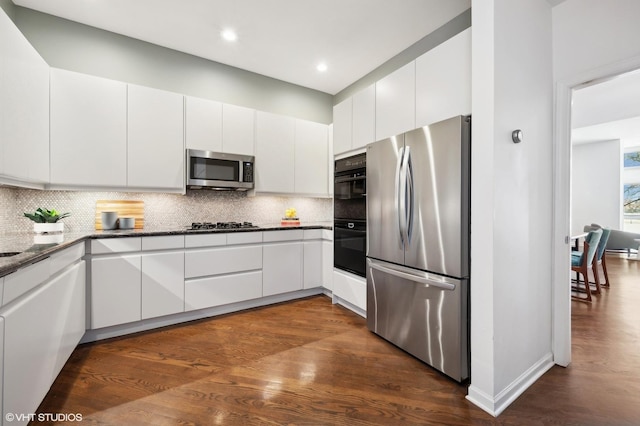 kitchen featuring stainless steel appliances, white cabinets, and decorative backsplash