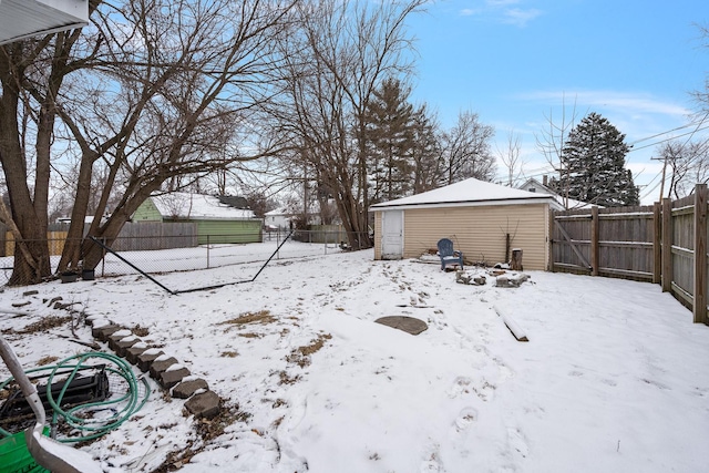 yard covered in snow with an outbuilding