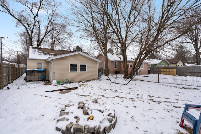 view of snow covered rear of property