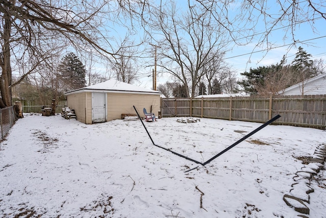 yard covered in snow featuring a storage unit