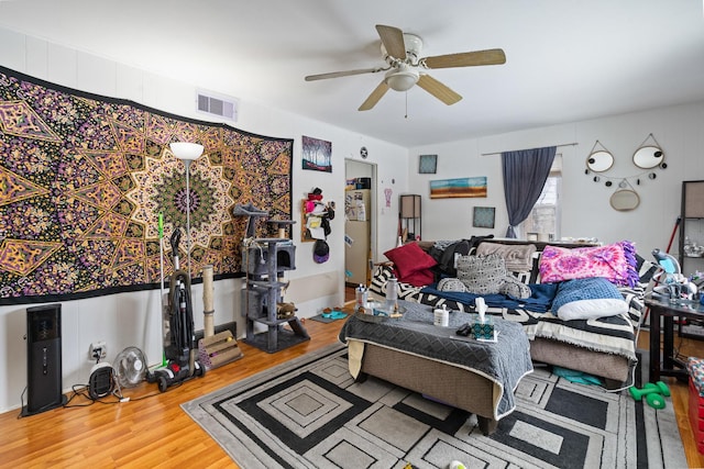 living room featuring hardwood / wood-style flooring and ceiling fan