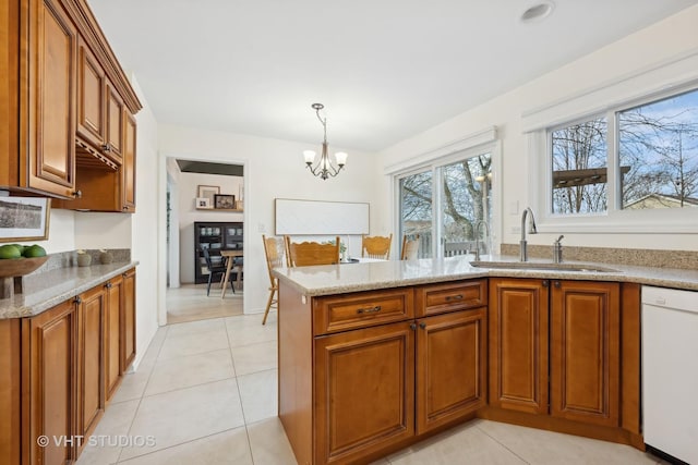 kitchen featuring sink, an inviting chandelier, light tile patterned floors, white dishwasher, and pendant lighting