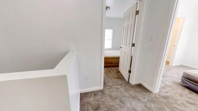 corridor featuring light colored carpet