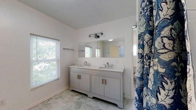 bathroom with vanity and vaulted ceiling