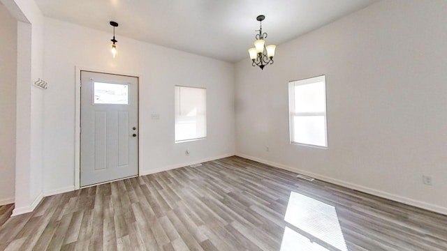 foyer featuring a chandelier and light wood-type flooring