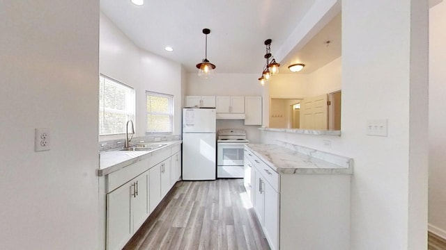 kitchen with sink, white appliances, light hardwood / wood-style flooring, white cabinetry, and hanging light fixtures