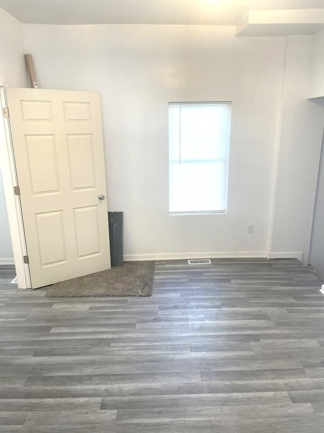 unfurnished bedroom with dark wood-type flooring