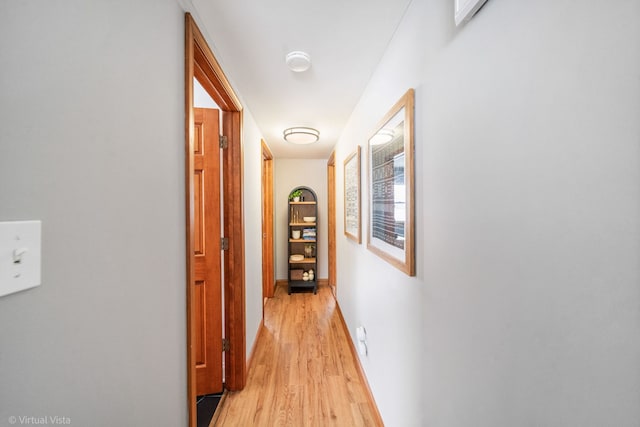 hallway with light hardwood / wood-style flooring