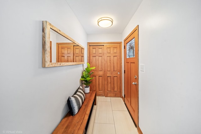 doorway with light tile patterned flooring