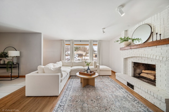 living room with a fireplace and light hardwood / wood-style flooring