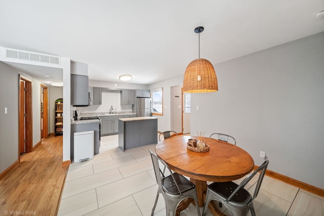 dining room featuring light tile patterned flooring and sink