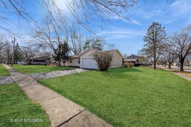 view of side of property with driveway, an attached garage, and a yard