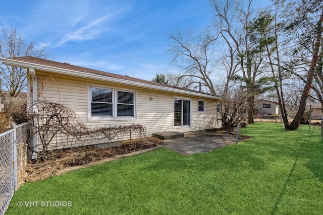 back of house featuring a yard, a patio area, and fence