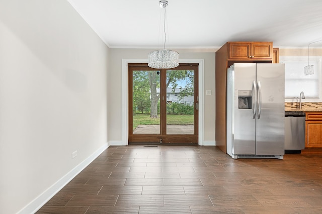 interior space with crown molding, dark wood-type flooring, a sink, and baseboards