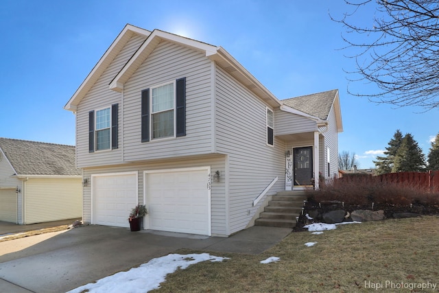 view of front of house with driveway, roof with shingles, and an attached garage