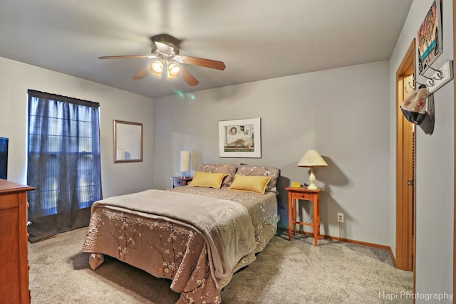 carpeted bedroom featuring ceiling fan and baseboards