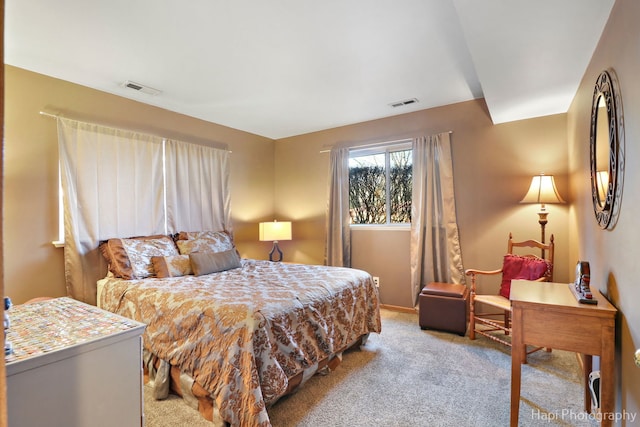 bedroom featuring light carpet and visible vents