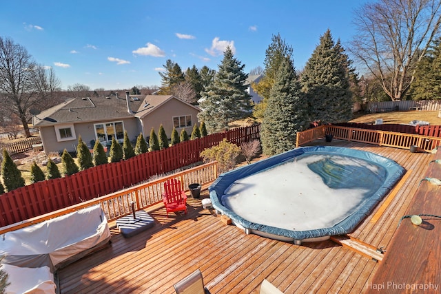 wooden deck featuring a fenced backyard