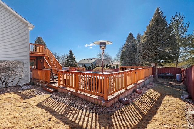 wooden deck featuring a fenced backyard