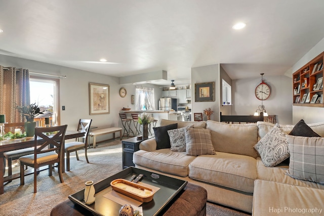 living room with light carpet, ceiling fan, and recessed lighting