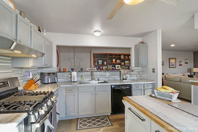 kitchen with dishwasher, hanging light fixtures, light countertops, stainless steel range with gas cooktop, and a sink