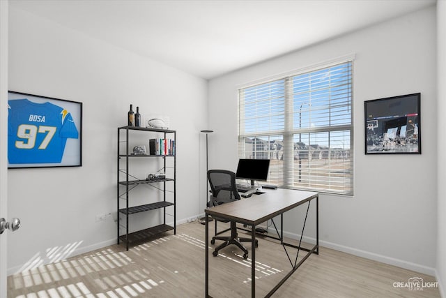 office area featuring baseboards and wood finished floors