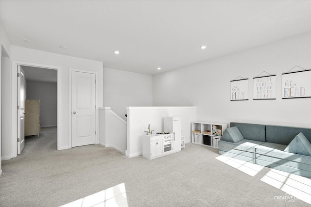 living room featuring light carpet, baseboards, and recessed lighting