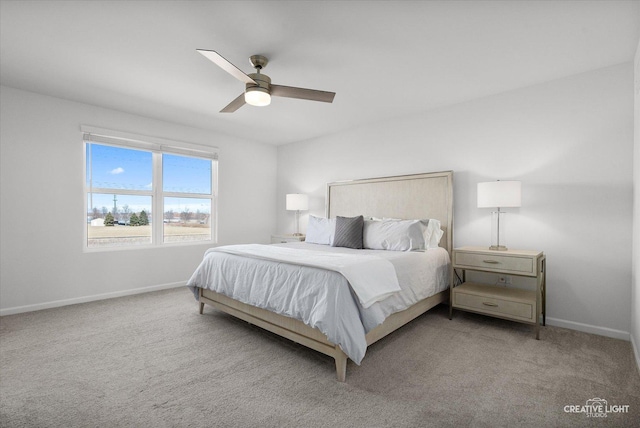 bedroom featuring light carpet, ceiling fan, and baseboards