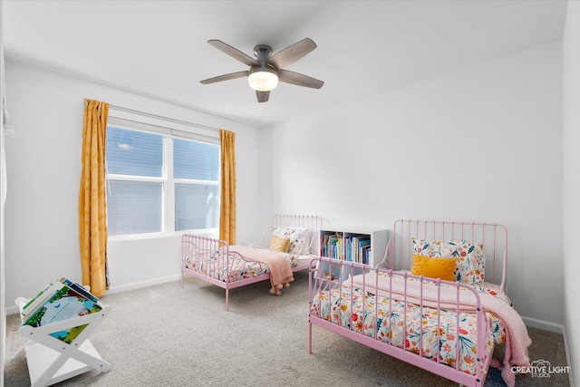 carpeted bedroom featuring a ceiling fan and baseboards