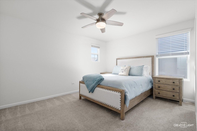 bedroom with baseboards, a ceiling fan, and light colored carpet