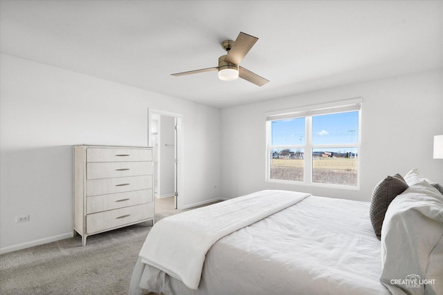 bedroom with light colored carpet, ceiling fan, and baseboards