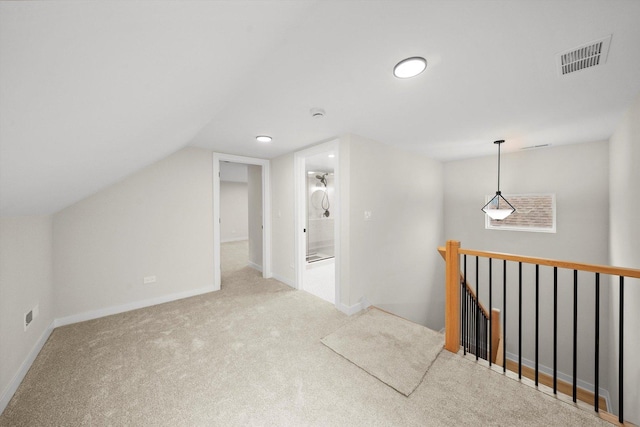 additional living space with vaulted ceiling and light carpet