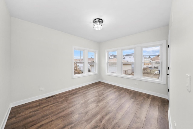 unfurnished dining area with dark wood-type flooring