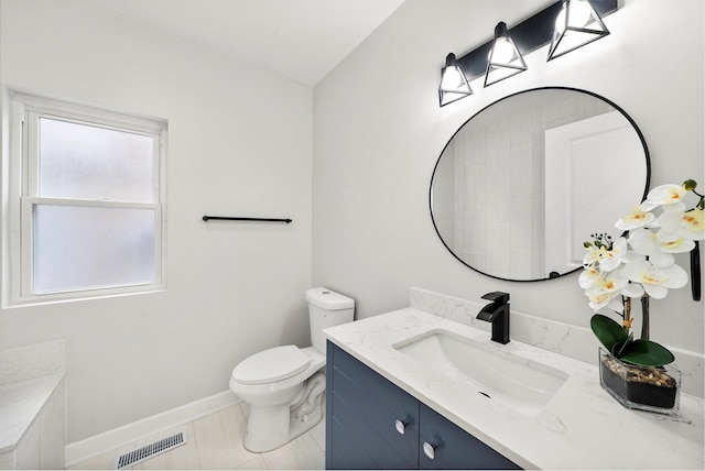 bathroom with tile patterned floors, vanity, and toilet