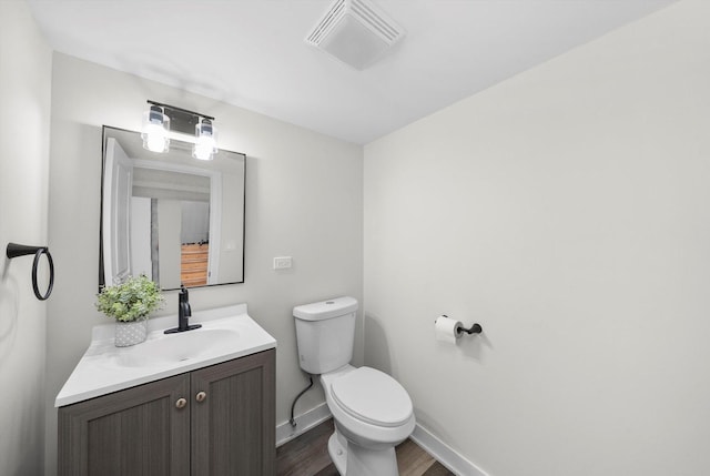 bathroom with vanity, hardwood / wood-style floors, and toilet