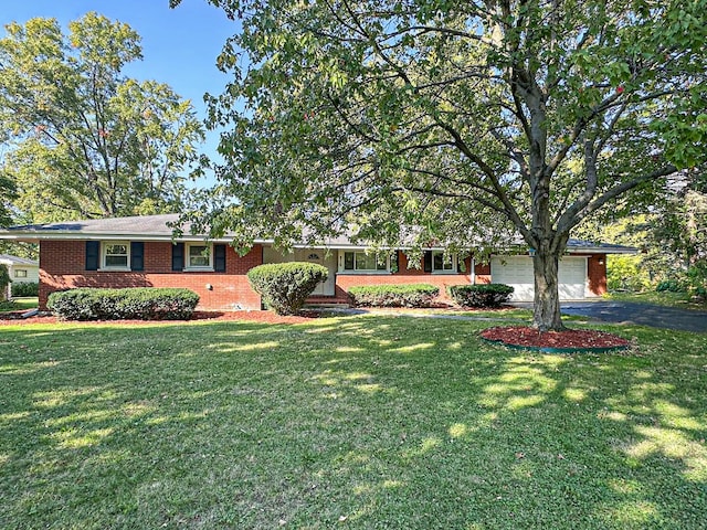 ranch-style house with a garage and a front yard