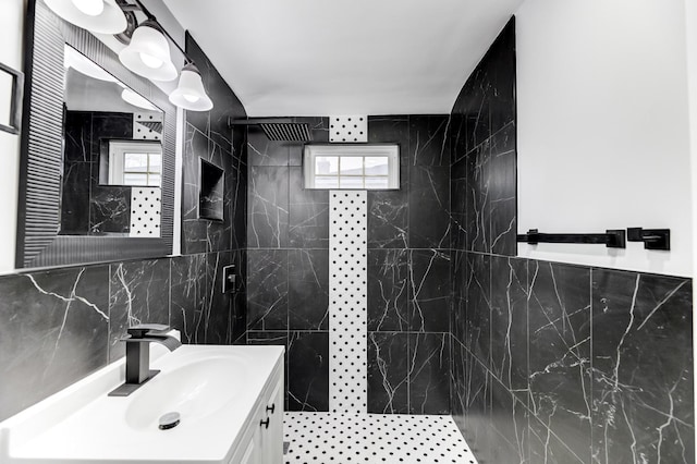 bathroom featuring vanity, tile walls, and a tile shower