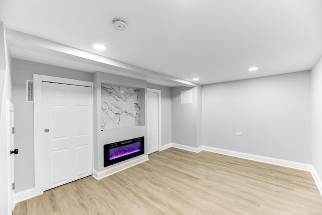 basement featuring light hardwood / wood-style flooring